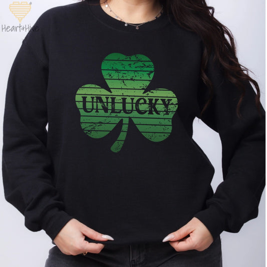 Black sweatshirt with distressed retro sunset style shamrock with 'unlucky' written in the center.