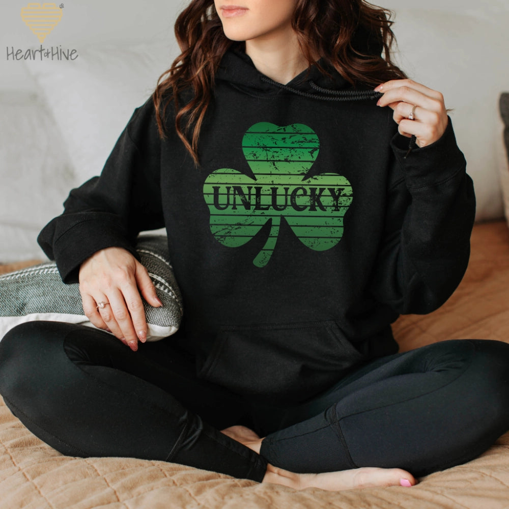 Black hoodie with distressed retro sunset style shamrock with 'unlucky' written in the center.
