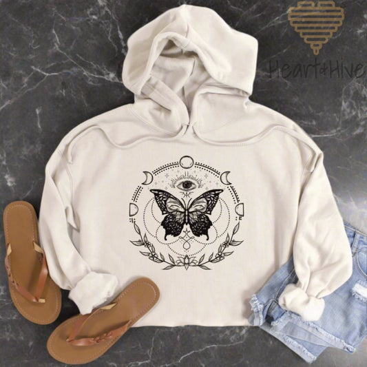 Heather dust cropped hoodie with a black design of a butterfly, all-seeing eye, crescent moons, celestial symbols, and botanicals.