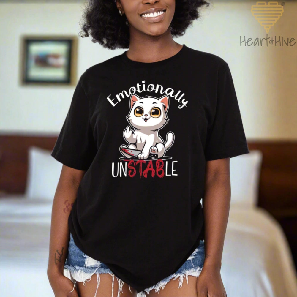 Black tee with a white cat holding a bloody knife with his middle finger up. 'Emotionally' is rounded above and unstable is written below with 'stab' red and dripping.