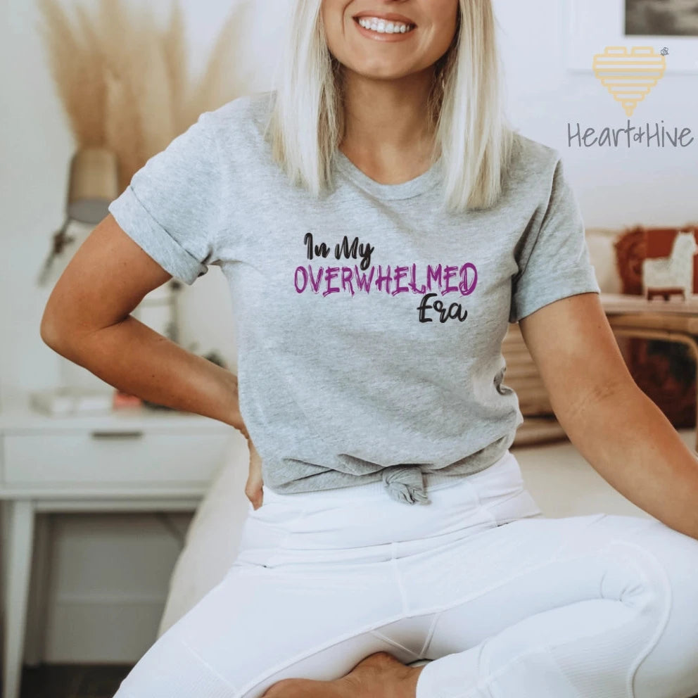 Athletic Heather Grey tee featuring the phrase "In My OVERWHELMED Era," with "OVERWHELMED" in purple font and the rest in black