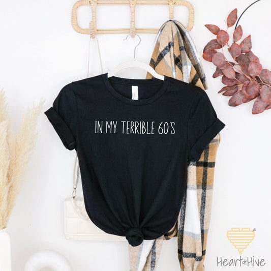 Black tee with the phrase "IN MY TERRIBLE 60’S" in white text