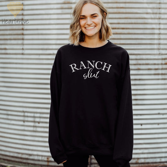 Black sweatshirt with, 'Ranch Slut' with Ranch written in a Western font and slut written in a cute cursive text.