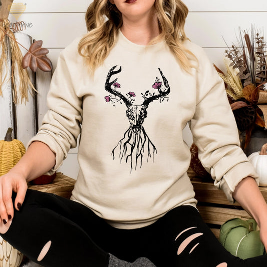 Sand sweatshirt featuring a deer skull with antlers, floral accents, and roots, blending rustic and boho aesthetics.