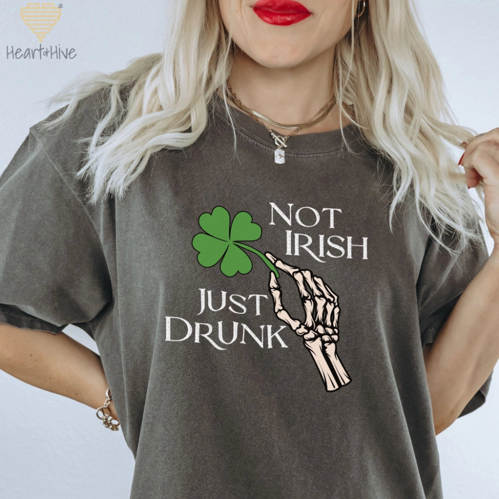 Pepper Comfort Colors Tee with skeleton hand holding a four-leaf clover that says 'Not Irish Just Drunk' in a distressed text.