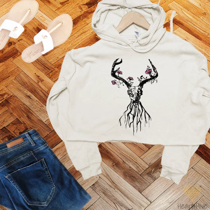 Heather dust crop hoodie featuring a deer skull with antlers, floral accents, and roots, blending rustic and boho aesthetics.