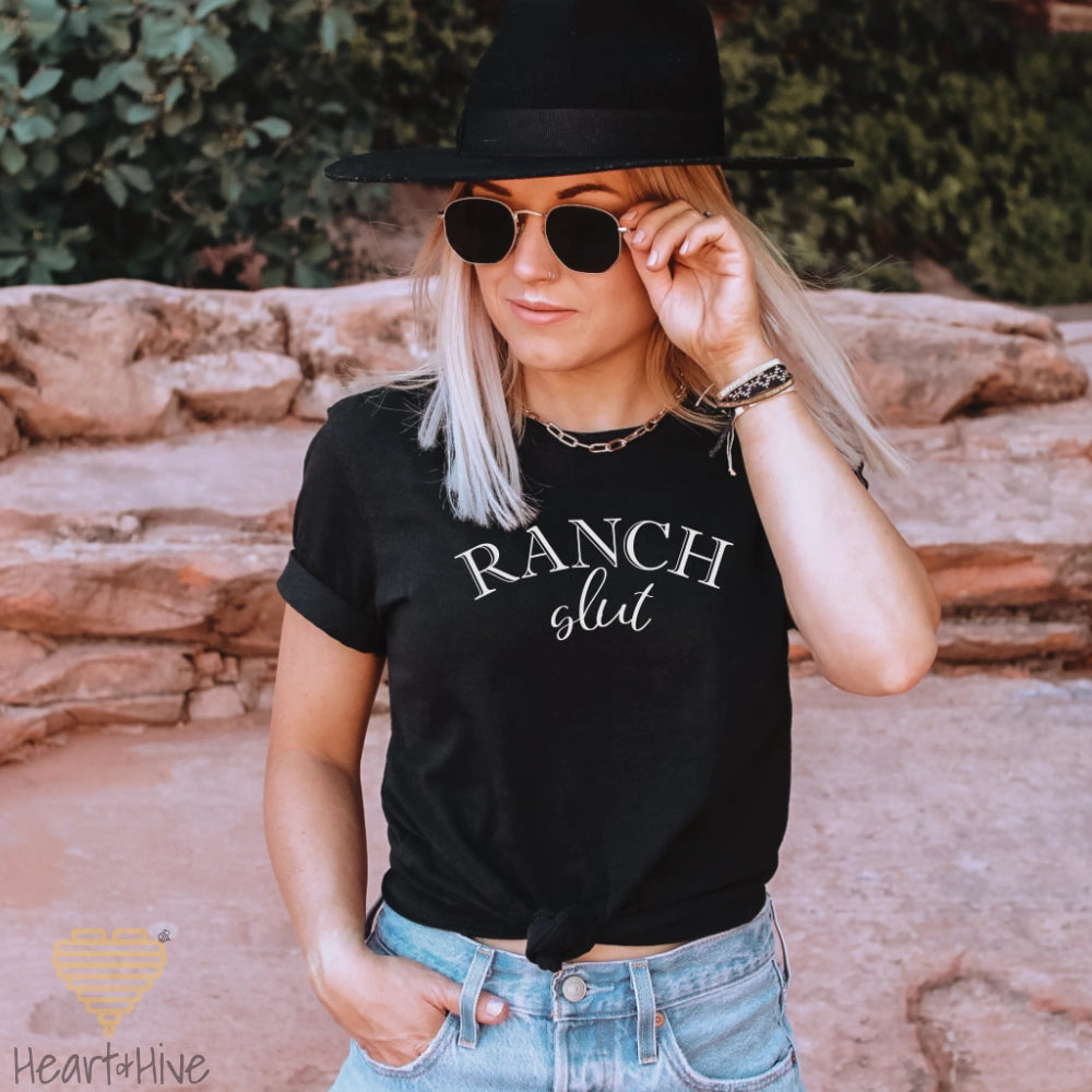 Black tee with, 'Ranch Slut' with Ranch written in a Western font and slut written in a cute cursive text. 