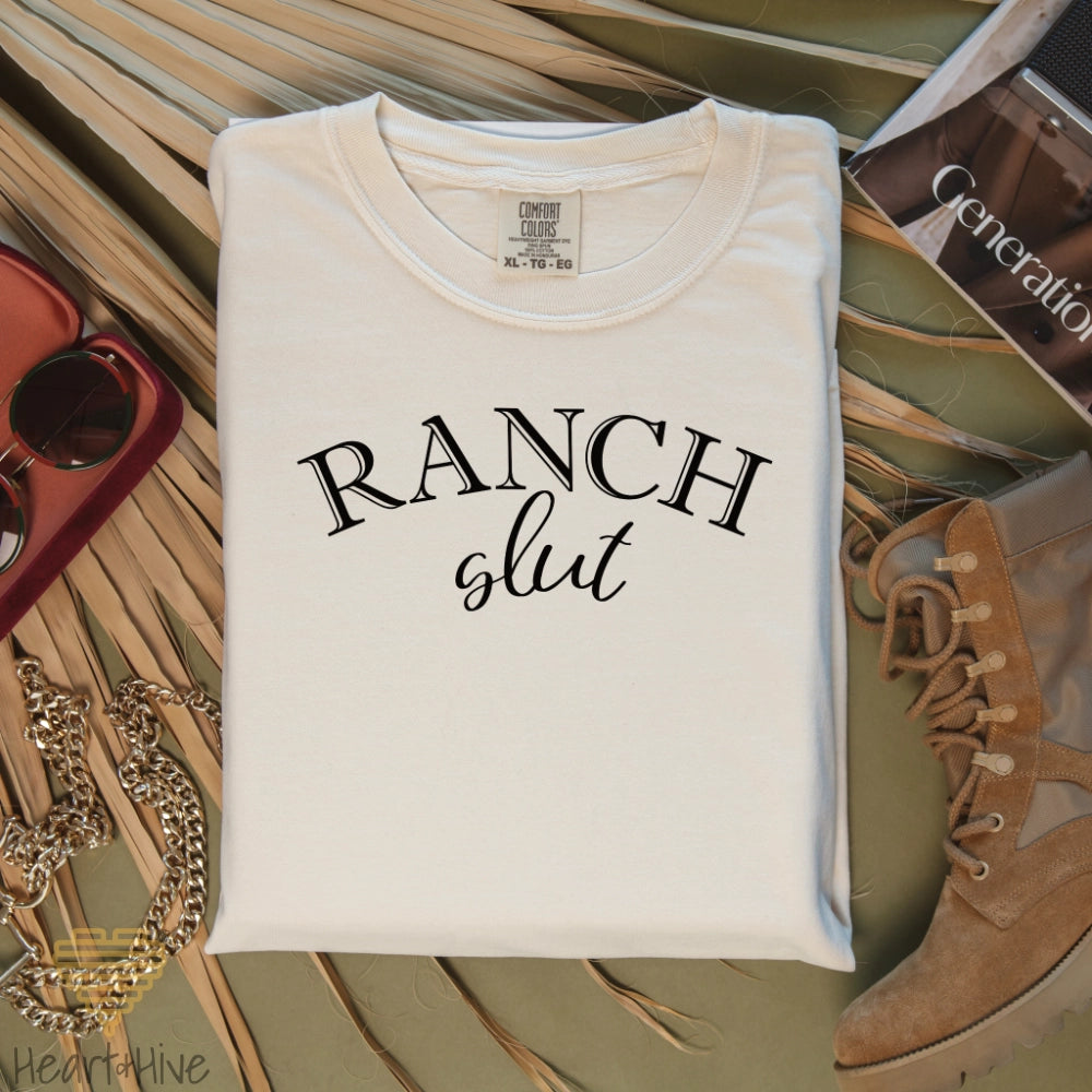 Ivory Comfort color tee with, 'Ranch Slut' with Ranch written in a Western font and slut written in a cute cursive text. 